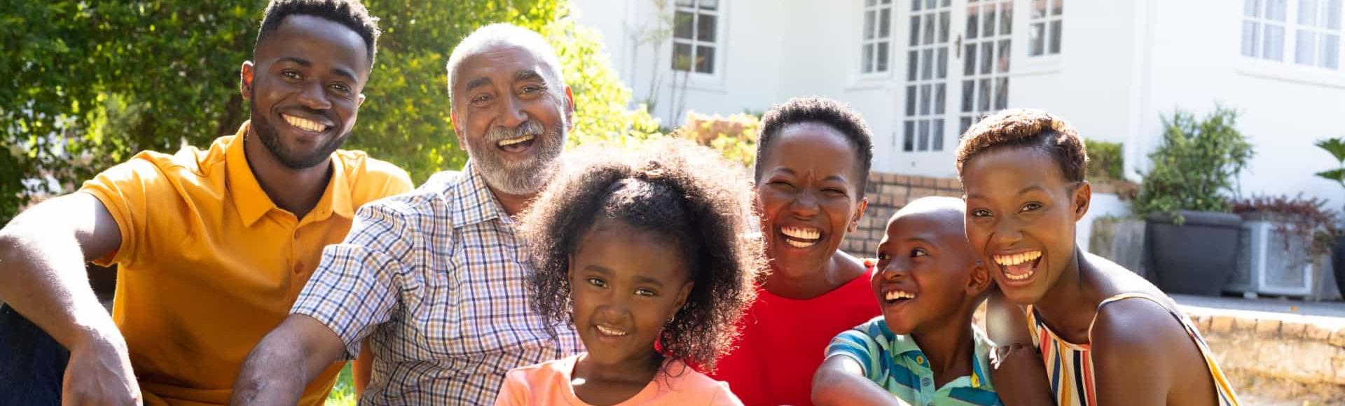 Multigenerational African American family in front of house