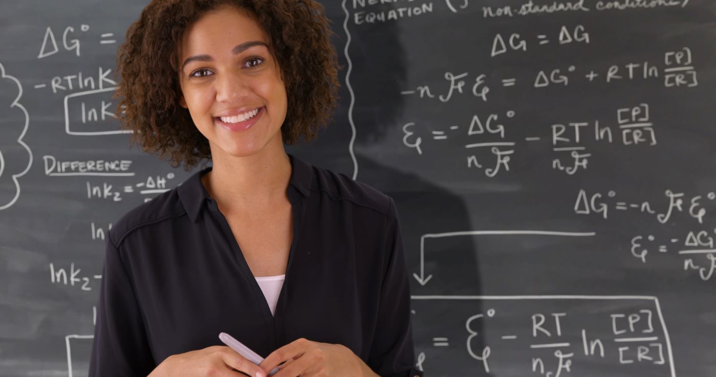 Woman Infront of a white board math problem 