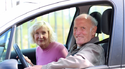 Older couple driving minivan