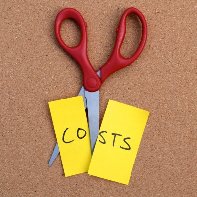 scissors cutting note that reads "costs"