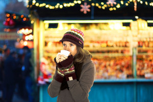 Woman drinking coffee at a Christmas market