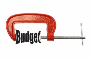 A vice squeezing the word "budget"