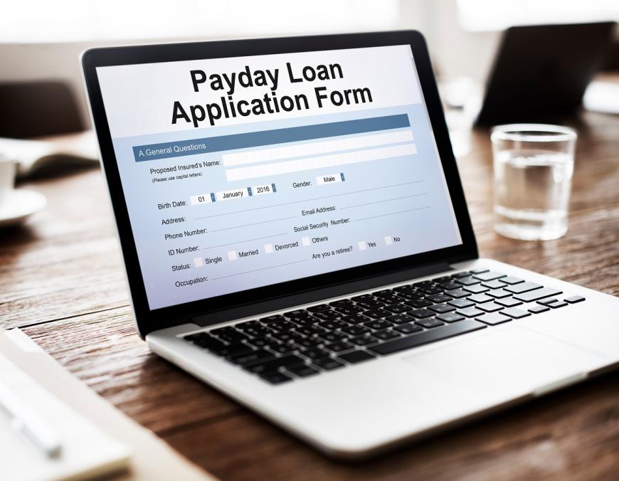 Laptop with the words Paycheck Loan Application Form on the screen