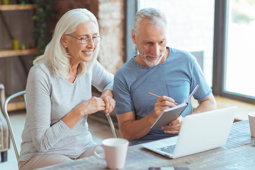 middle aged man and woman on laptop