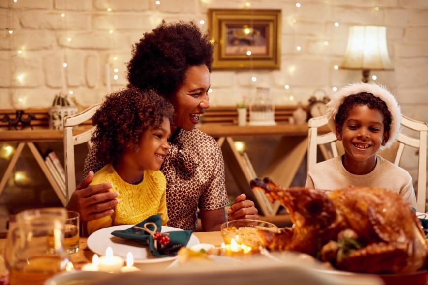 African American mom and two children enjoying holiday meal