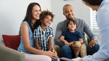 Multiracial family talking with financial advisor