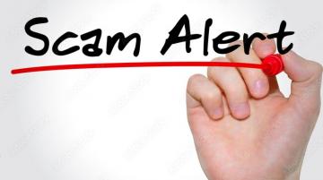 Individual's hand writing Scam Alert