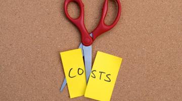 Scissors cutting a post it note that says "Costs"