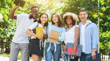 Happy, multiracial group of five college students