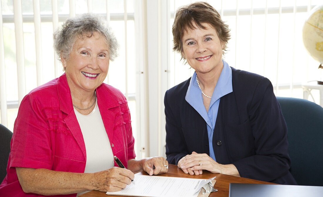 Elderly Woman consulting a financial counselor.