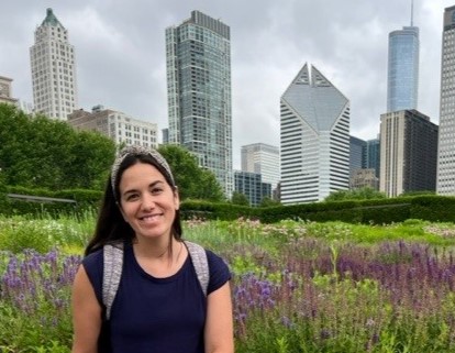 Jessika Evans sitting in a field of lavender, surrounded by the Minneapolis city scape  