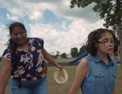 Zuleyka (right) plays at her neighborhood park with Lucia Hernandez Sanchez, her caregiver.