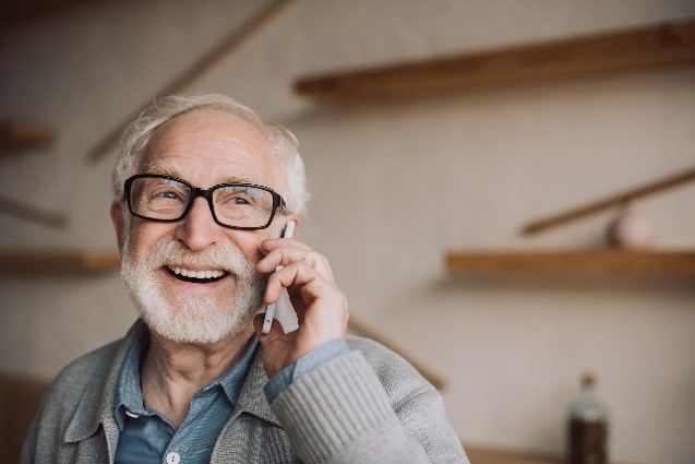 Man smiling while on the phone