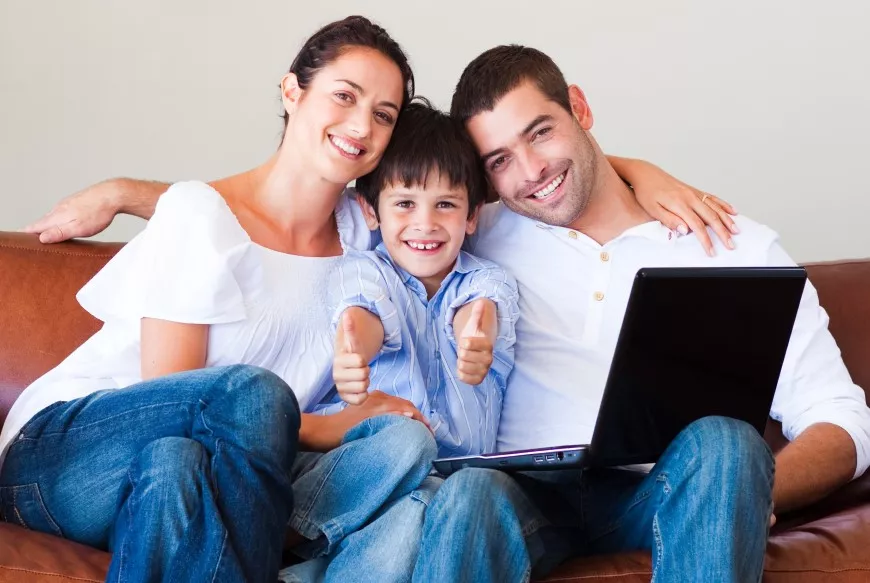 Family on couch with computer