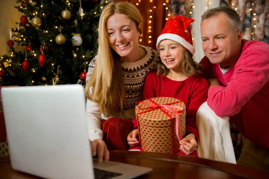Family with computer and Christmas tree