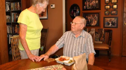 Older adult receiving a home delivered meal.