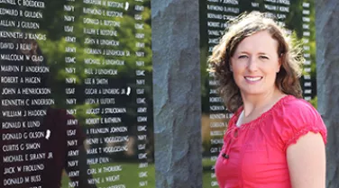 Therapist and veteran Jolaina Falkenstein next to a war memorial